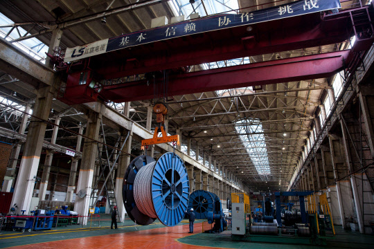 LS전선, 중국 법인 통해 580억원 쿠웨이트 지중케이블 수주   LS전선이 중국 생산법인 LS홍치전선이 쿠웨이트 수전력부와 5천300만달러(한화 580억원) 규모의 '초고압 지중케이블' 계약을 체결했다고 12일 전했다. 사진은 LS홍치전선 공장 내 초고압 케이블을 옮기는 모습. 2017.12.12 [LS전선 제공=연합뉴스]